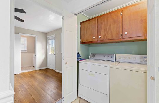 laundry area, access to primary bedroom