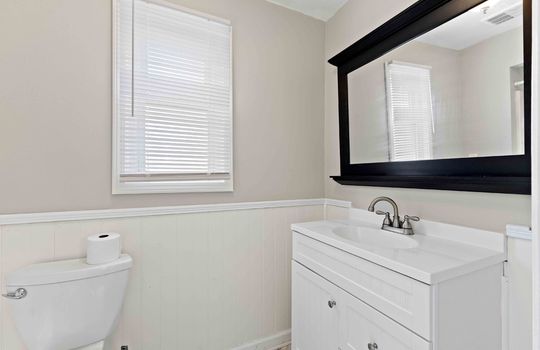 ensuite bath, primary bathroom, sink, toilet, wainscoting, window