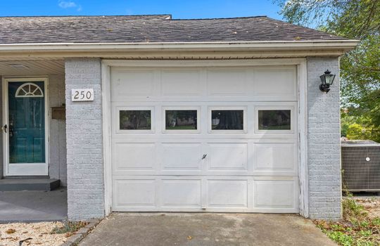 garage door, brick exterior, driveway