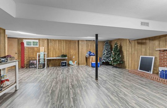 lower level bonus room, vinyl flooring, stairs to upper level, window