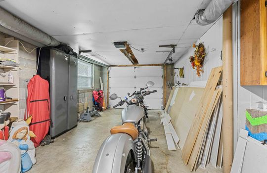 lower level garage access, garage door, concrete flooring