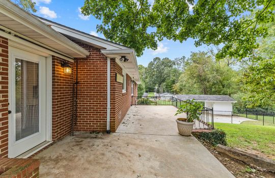 back of home, brick ranch, concrete patio