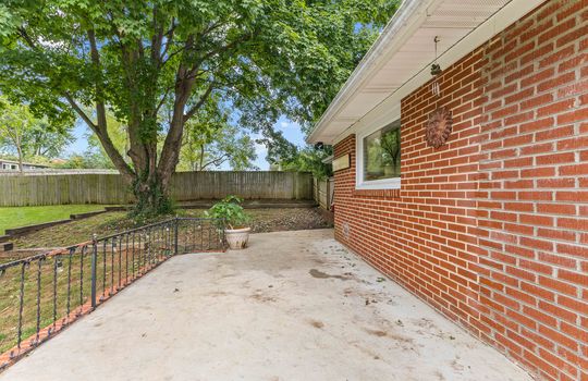 back of home, brick ranch, concrete patio