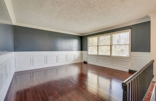 living room, wainscoting, large window, hardwood flooring