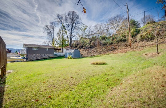 split foyer, back of home, yard, stoarage shed