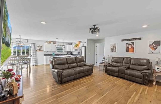 living room, laminate flooring, open floorplan, recessed lighting