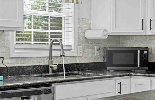 kitchen, tile backsplash, granite countertops, cabinets, sink, window above sink, cabinets