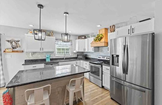 kitchen, recessed lighting, cabinets, granite countertops, dishwasher, sink, oven/range, refrigerator, tile backsplash, kitchen island, laminate flooring