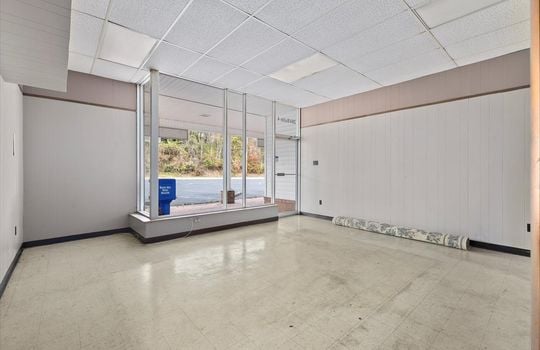 business space interior, concrete flooring, glass business front, glass business door