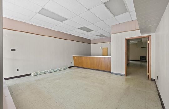 reception/waiting area, concrete flooring, doorway