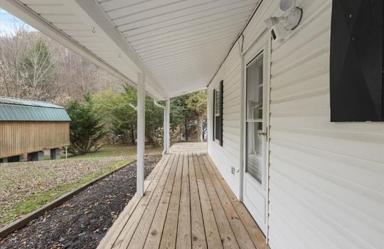 covered front porch, front door, vinyl siding