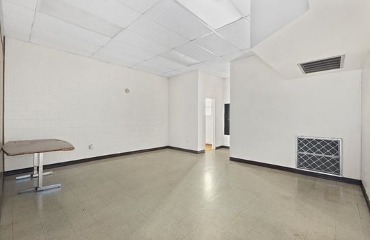 office, concrete flooring, ceiling tiles, fluorescent lighting