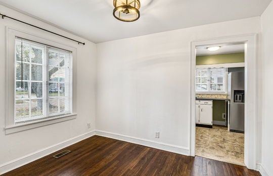 dining space, hardwood flooring, door to kitchen