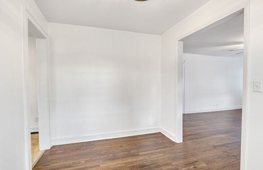 dining space, doorway to living room, doorway to kitchen, hardwood flooring