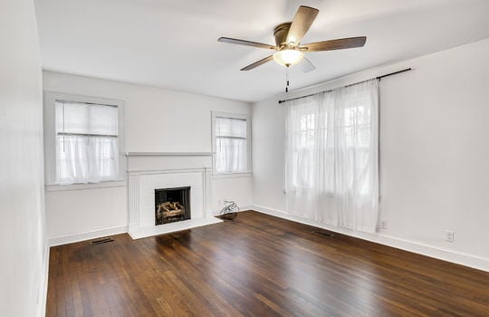 living room, hardwood flooring, ceiling fan, fireplace