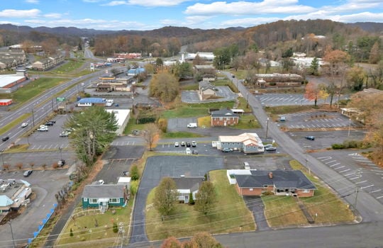 aerial photo of property, front view of property, front yard, back parking lot, neighboring homes & businesses, roads, mountain views