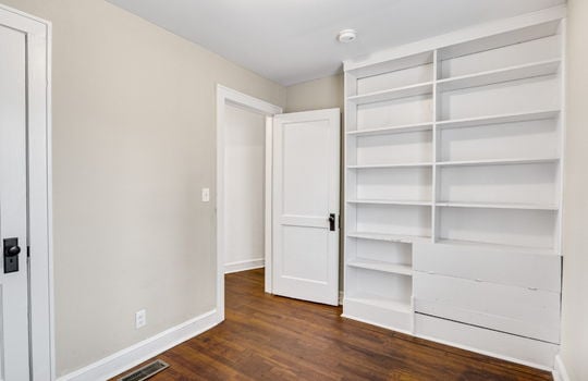 bedroom, hardwood flooring, built in shelving