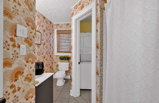 bathroom, tile flooring, sink, toilet, laundry area