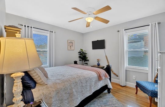 bedroom or office, ceiling fan, hardwood flooring, windows