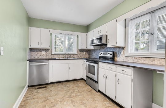 kitchen, tile flooring, dishwasher, microwave, stove, cabinets, countertops, windows, sink