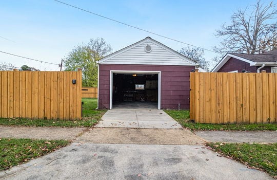 driveway, security fence open, garage door open