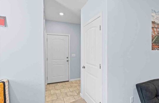 hallway, tile flooring, closets, doors