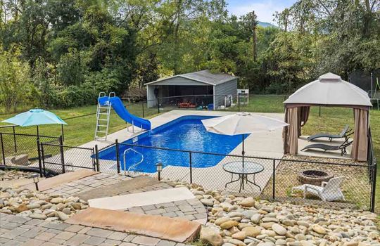 back yard, firepit, fencing, swimming pool, slide, pergola, carport