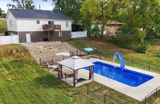 back yard view toward back of home, swimming pool, fencing, pergola, firepit, back deck, back of home, vinyl siding, patio