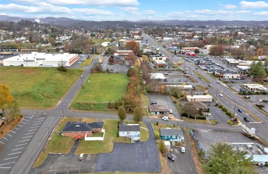 aerial photo of property, front view of property, front yard, back parking lot, neighboring homes & businesses, roads, mountain views