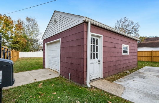 garage/storage shed, door, garage door, parking pad