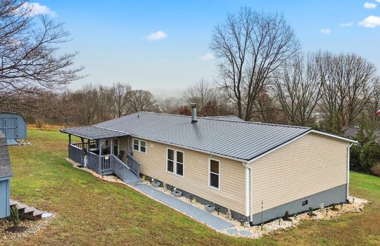 front right view, double wide, ramp access, front porch, covered front porch, double wide, vinyl siding, metal roof, landscaping, mountain views