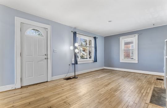 living room, front door, hardwood flooring, windows