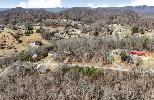 aerial view of land, neighboring properties, mountain views