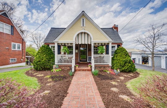 brick traditional home, brick, front porch, covered front porch, front door, brick sidewalk, landscaping, front yard, driveway