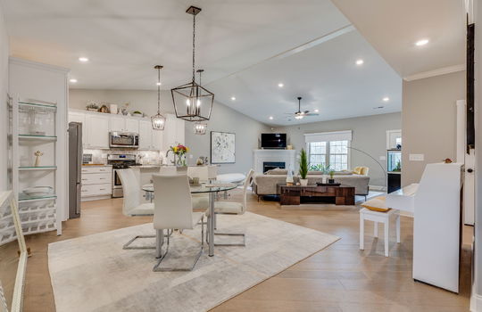 open floorplan, ktichen, living room, dining room, luxury vinyl tile, recessed lighting, vaulted ceilings