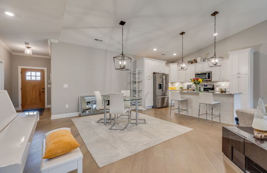 open floorplan, dining area, kitchen island, kitchen, vaulted ceiling, recessed lighting, luxury vinyl flooring
