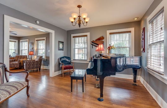 formal dining room, hardwood flooring windows, doorway to living room