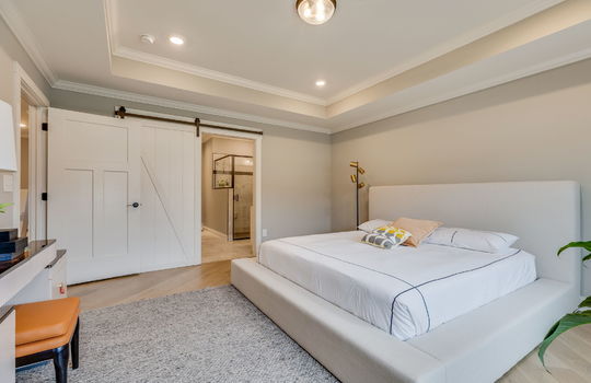bedroom, luxury vinyl flooring, tray ceilings, recessed lighting, barn door, ensuite bath