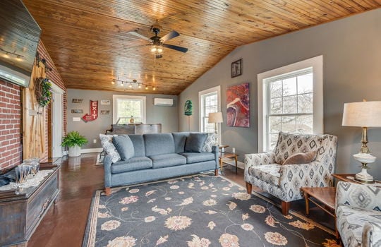 vaulted ceiling, bedroom/den, ceiling fan, windows, concrete flooring