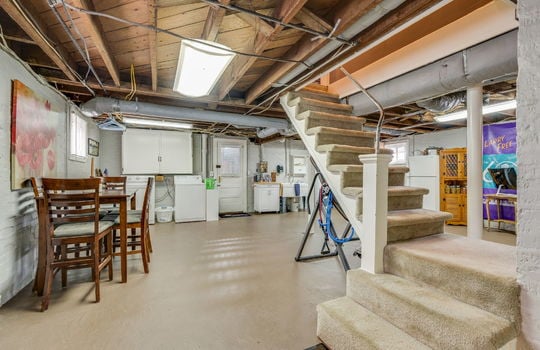 basement, carpeted stairs, exterior door, concrete flooring, washer/dryer hookup