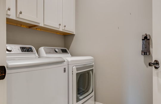 laundry area, cabinets, tile flooring