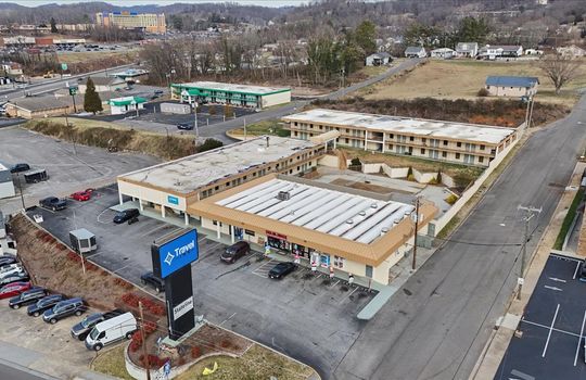 aerial view of shopping plaza, commercial property for lease, parking lot, neighboring businesses, road, hard rock casino & hotel