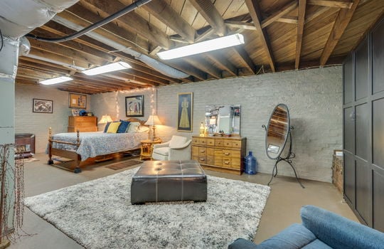 basement, painted brick wall, concrete flooring, fluorescent lighting, heated/cooled