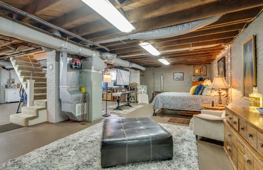 basement, painted brick wall, concrete flooring, fluorescent lighting, heated/cooled