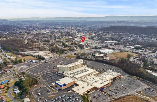 Aerial view of property with marker, roads, neighboring businesses, mountain views, hard rock casino