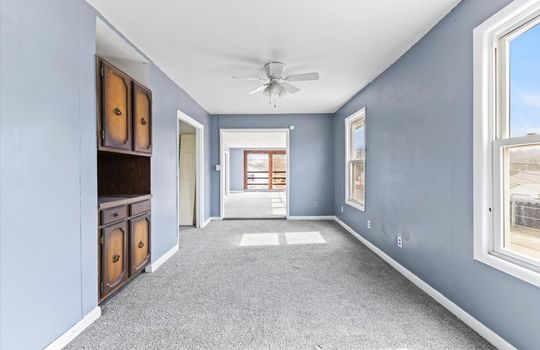 dining space, built in cabinet, carpet, windows