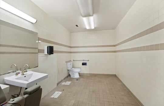 bathroom, tile walls, tile flooring, sink, fluorescent lighting