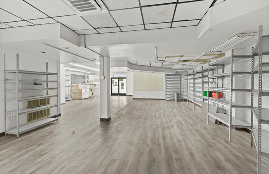 commercial property for lease, shelving, windows, double door entrance, ceiling tiles, fluorescent lighting