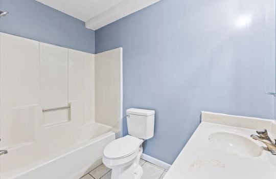 bathroom, sink, toilet, shower/tub, tile flooring