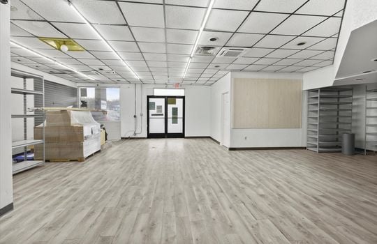 commercial property for lease, shelving, windows, double door entrance, ceiling tiles, fluorescent lighting